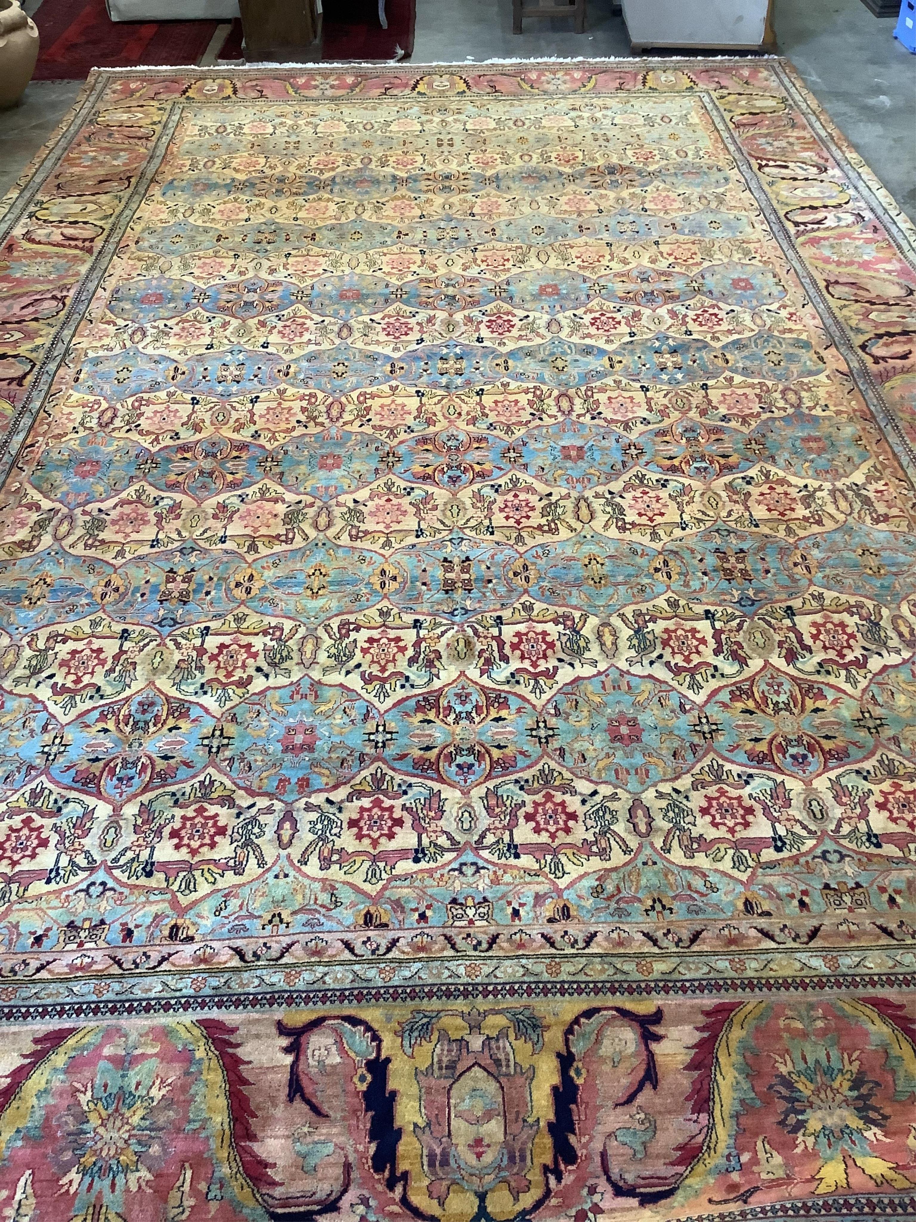 A large Persian design ivory ground carpet, 590 x 365cm. Condition - good